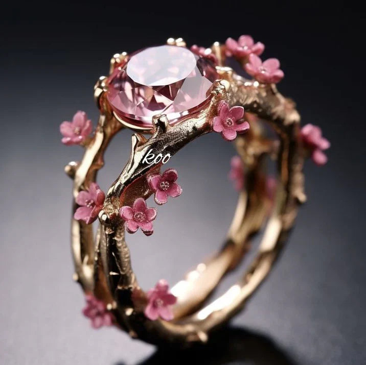 Exotischer Ring mit rosa Blume und goldenem Kristall